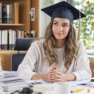 Graduate student studying with books and papers around.