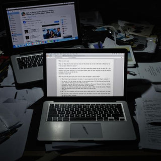 Cluttered desk with laptop and coffee, late-night urgency.