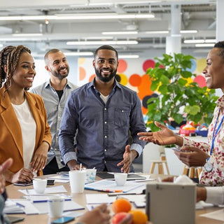 Diverse group of leaders collaborating in a bright workspace.