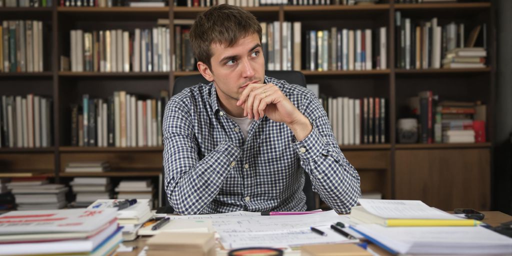 Student studying risk management in a cozy study area.