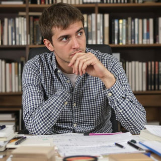 Student studying risk management in a cozy study area.