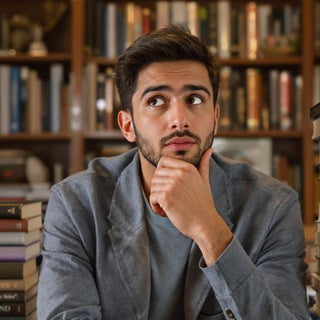 Student pondering ethics in a cozy study environment.