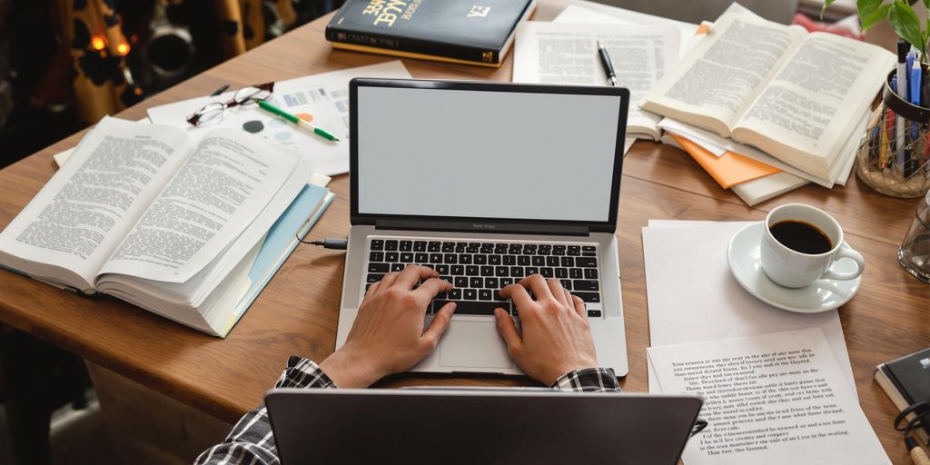 A student focused on writing at a desk.