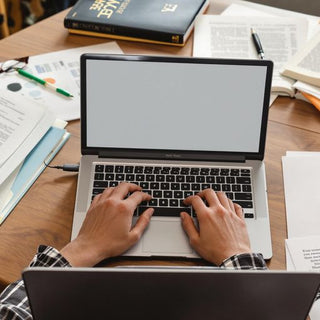 A student focused on writing at a desk.