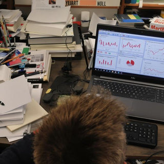 Student confused at desk with supply chain management materials.