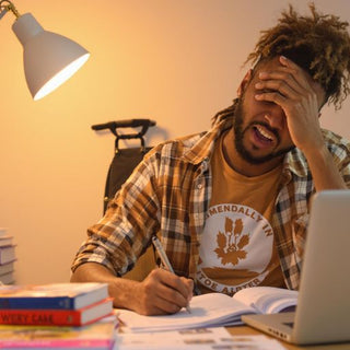 Motivated student studying at a desk with books.