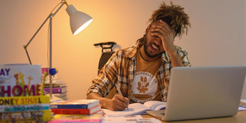 Motivated student studying at a desk with books.