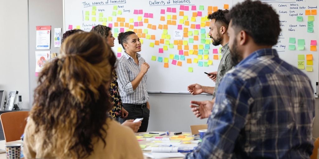 Diverse team collaborating in a lively office setting.