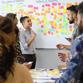 Diverse team collaborating in a lively office setting.