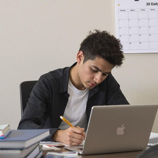 Student working diligently on a thesis in a cozy space.