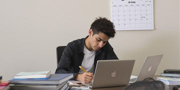 Student working diligently on a thesis in a cozy space.