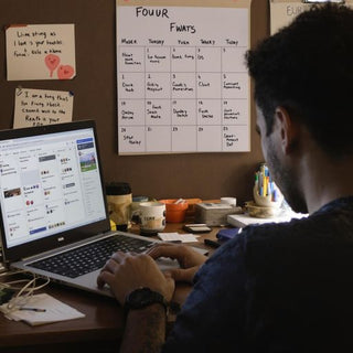 Student working diligently on thesis in study space.