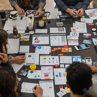 Group discussing consumer trends and analysis around a table.