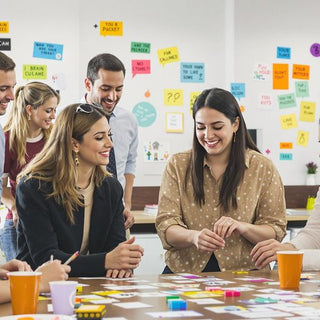 Diverse employees collaborating on puzzles in an office setting.