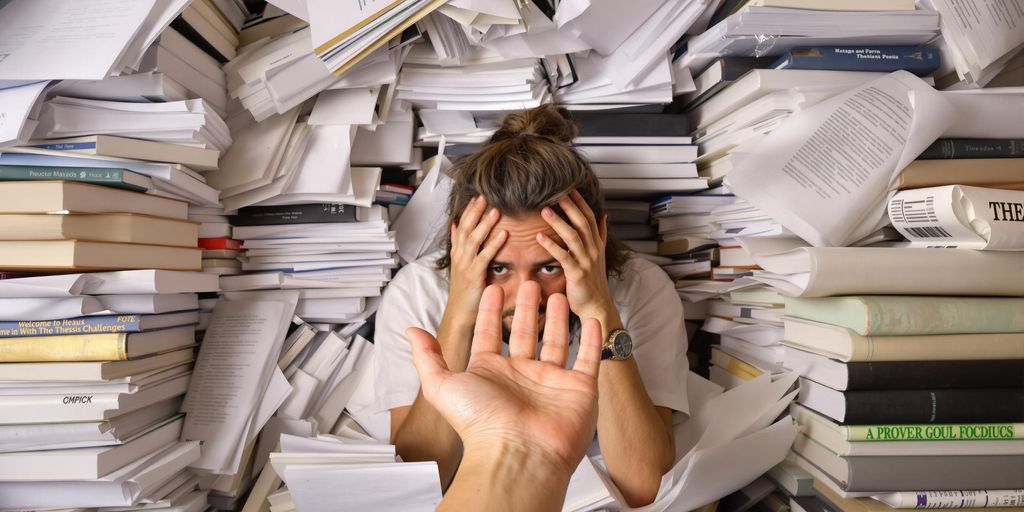 Stressed student with books seeking help for thesis.