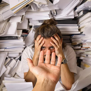 Stressed student with books seeking help for thesis.