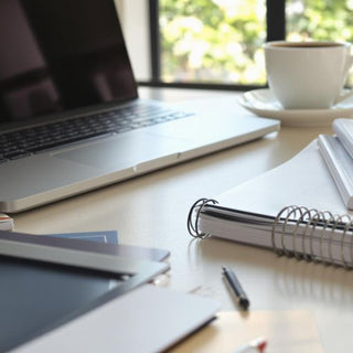 Inspiring workspace with laptop and notebooks.